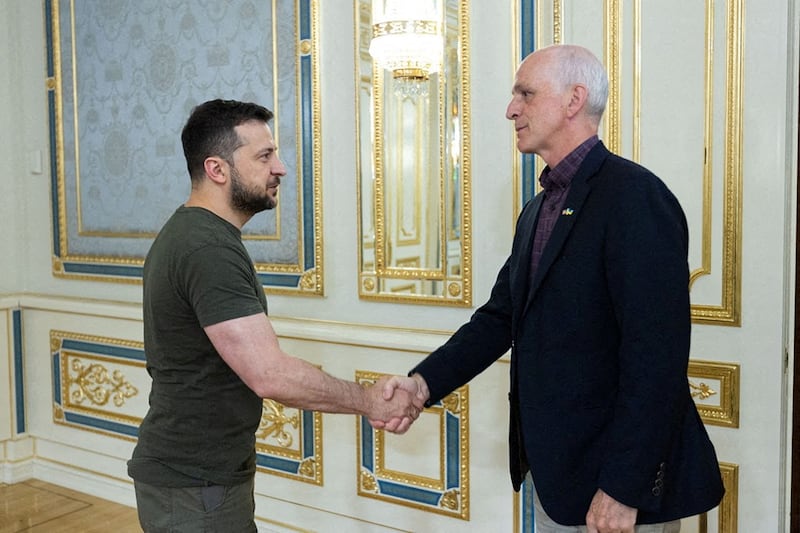 Ukraine President Volodymyr Zelensky shakes hands with Rep. Adam Smith in Kyiv, Ukraine.