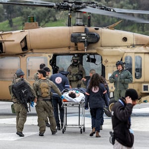 An Israeli medical team transports a person wounded in a rocket attack fired from southern Lebanon at Ziv hospital in Israel’s northern city of Safed on February 14, 2024. 