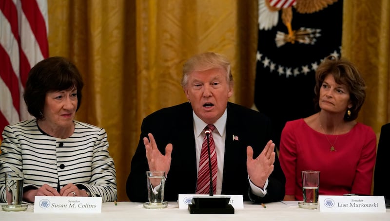 U.S. President Donald Trump meets with Senate Republicans at the White House on June 27, 2017. Trump is flanked by Senators Susan Collins (R-ME) and Sen. Lisa Murkowski (R-AK).