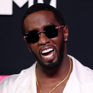 Sean “Diddy” Combs poses with his mouth open and sunglasses on.