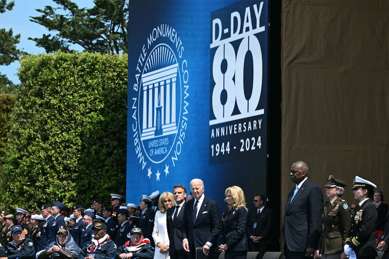 Joe Biden, Jill Biden, Emmanual Macron and Brigitte Macron stand on stage. 