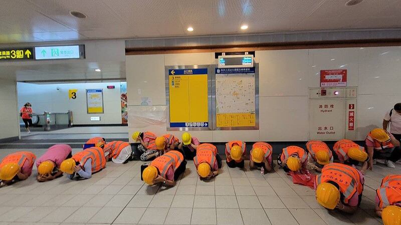 A photo of people wearing helmets and vests take part in a safety drill in Taipei City.