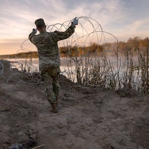 Texas National Guard soldiers install additional razor wire lie along the Rio Grande on January 10, 2024 in Eagle Pass, Texas.