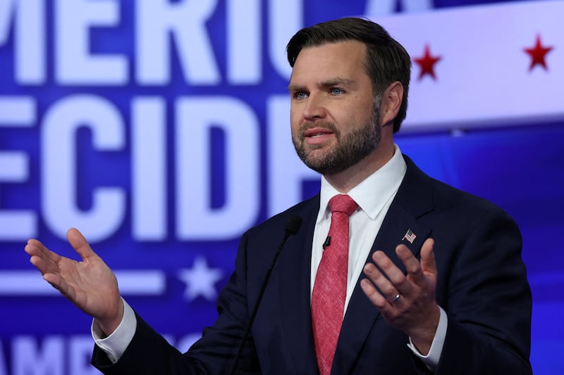 J.D. Vance speaks on stage during debate.