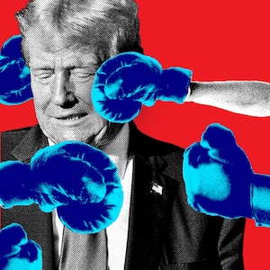 A photo illustration with Donald Trump with blue boxer gloves aiming at him on a red background