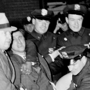 Police arrest Isidore Greenbaum during a Nazi meeting at Madison Square Garden.