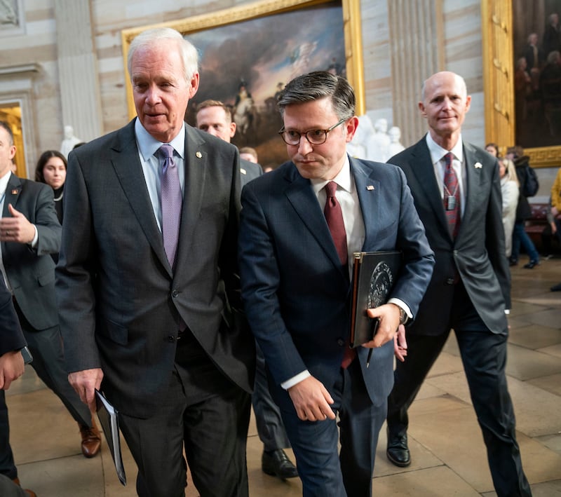 Speaker of the House Mike Johnson (R-LA) (center) walks through the United States Capitol Rotunda with Senators Ron Johnson (R-WI), left, and Rick Scott (R-FL).