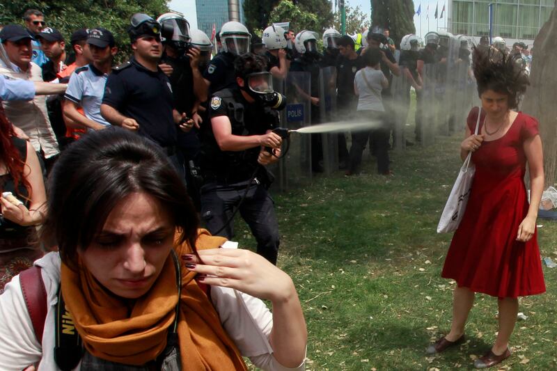 articles/2013/06/06/turkish-protesters-are-entrenched-as-protests-continue/130605-giglio-turkey-protests-embed-woman-in-red-dress_cvhjjm