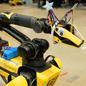 Boston Dynamics' Spot robot wearing googly eyes and a hat