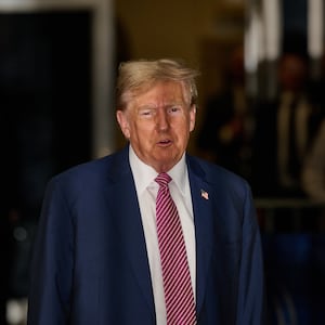 Former President Donald Trump speaks to the media as he enters Manhattan Criminal Court.