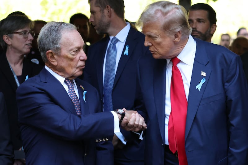 Former New York City Mayor Michael Bloomberg and former President Donald Trump shake hands. 