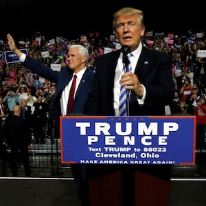 Republican U.S. presidential nominee Donald Trump (R) and vice presidential nominee Mike Pence (L) hold a campaign rally in Cleveland, Ohio, U.S. October 22, 2016. 