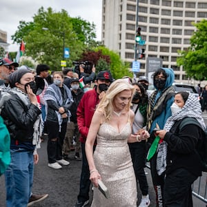 A guest is confronted by pro-Palestinian protestors demonstrate outside the White House Correspondents' Association (WHCA) dinner at the Washington Hilton, in Washington, DC, on April 27, 2024. 