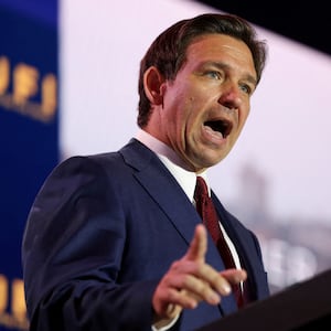 Presidential candidate Ron DeSantis speaks at a podium during a summit in July.