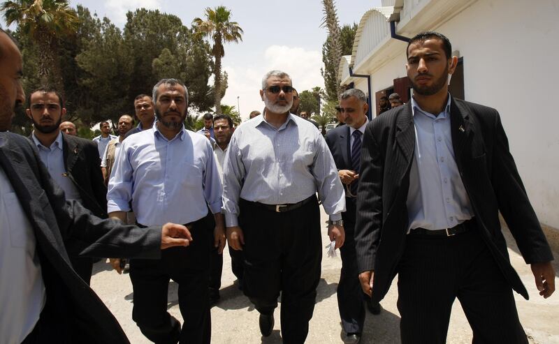 Senior Hamas leader Ismail Haniyah is surrounded by bodyguards during his visit to the Rafah border crossing in the southern Palestinian territory on June 27, 2009