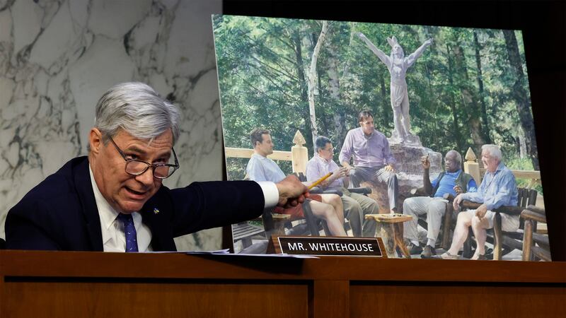 Senate Judiciary Committee member Sen. Sheldon Whitehouse (D-RI) displays a copy of a painting featuring Supreme Court Associate Justice Clarence Thomas alongside other conservative leaders during a hearing on Supreme Court ethics reform. 