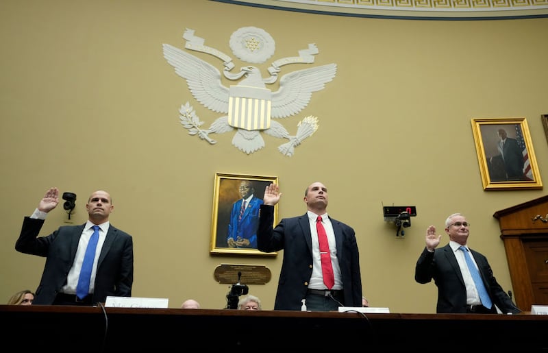 Ryan Graves, David Grusch, and David Fravor swear into a hearing regarding UFOs on Wednesday.