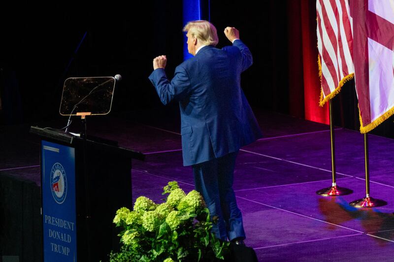 Former US President and 2024 hopeful Donald Trump dances as he leaves after speaking at the Alabama Republican Party's summer dinner in Montgomery, Alabama.