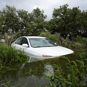 A vehicle is partially submerged after the arrival of Hurricane Idalia, in Cedar Key, Florida