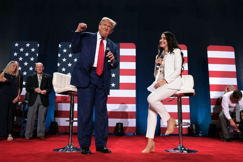 Rep. Anna Paulina Luna, right, joins former President Donald Trump at a town hall event.