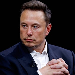 Elon Musk wearing a suit