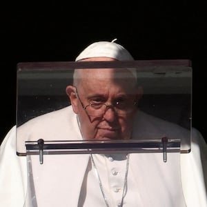 Pope Francis looks on to lead the Angelus prayer from his window