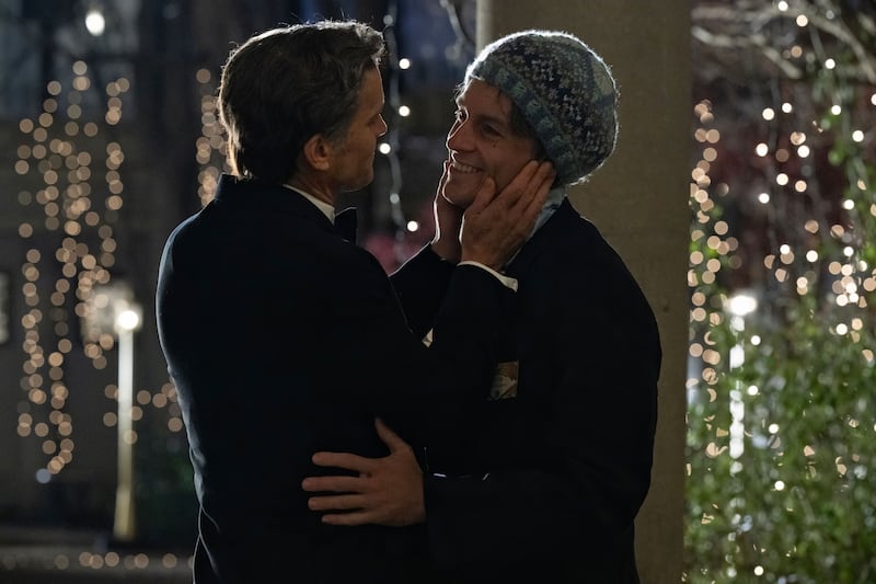 Matt Bomer and Jonathan Bailey hug in a still from ‘Fellow Travelers’