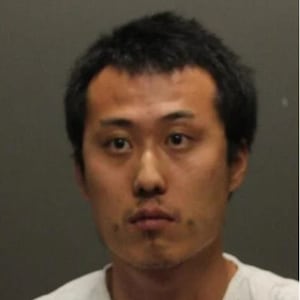 A booking photo of Michael Penchung Lee and a photo of a sign on the University of Arizona campus declaring it a “weapon free zone.”