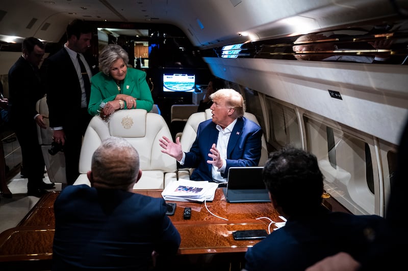 Susie Wiles stands by as former president Donald Trump speaks to staff and reporters aboard his airplane, known as "Trump Force One," as he travels home after speaking in GA to NC on Saturday, June 10, 2023, in Greensboro, NC.