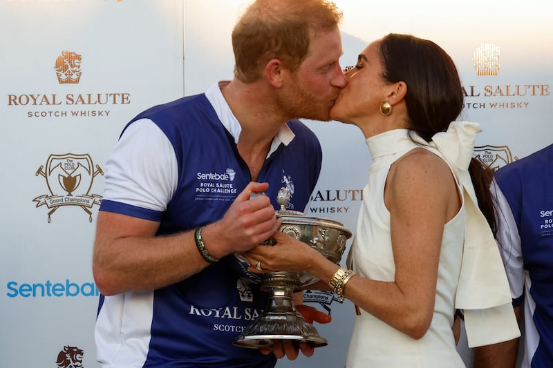 Prince Harry and Meghan Markle kiss as they attend the Royal Salute Polo Challenge to benefit Sentebale, a charity founded by him and Prince Seeiso of Lesotho to support children in Lesotho and Botswana, in Wellington, Florida, U.S., April 12, 2024.