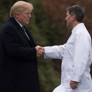 US President Donald Trump shakes hands with Dr. Ronny Jackson