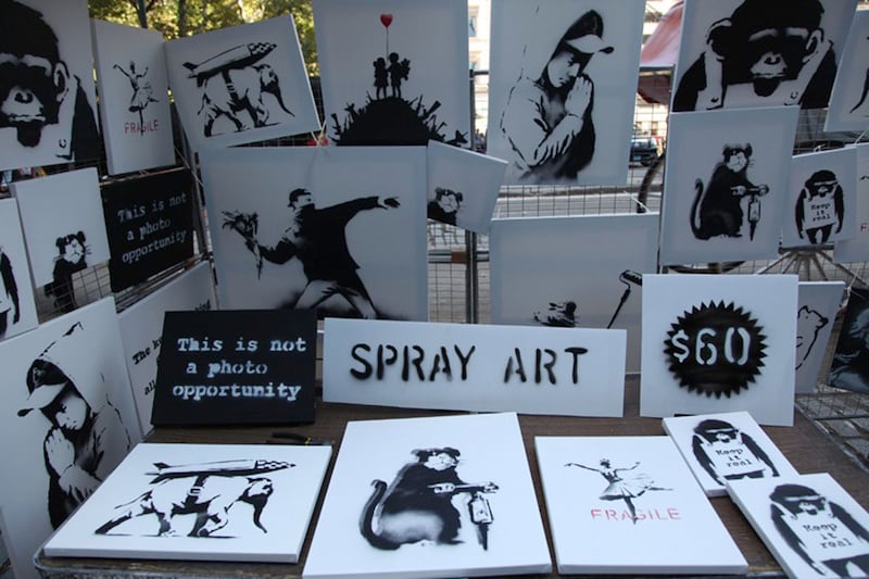 articles/2013/10/14/banksy-s-biggest-trick-yet-selling-his-art-on-the-street-for-60/131014-banksy-stall-wilkinson-tease_jexea4