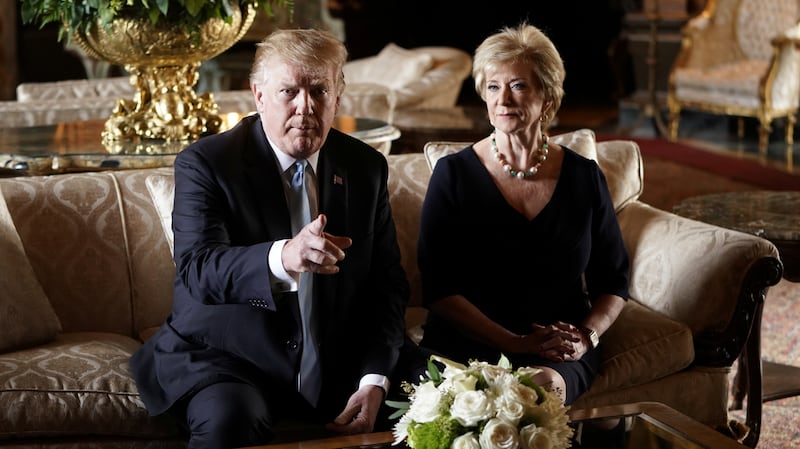 U.S. President Donald Trump talks to reporters about the resignation of Linda McMahon, Administrator of the Small Business Administration, as she sits beside him at Trump's Mar-a-Lago estate.