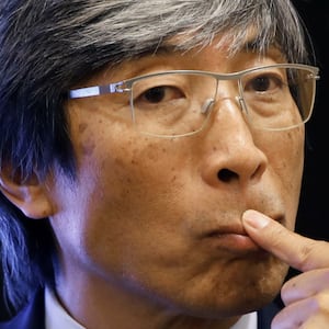 Patrick Soon-Shiong puts a finger to his lip.