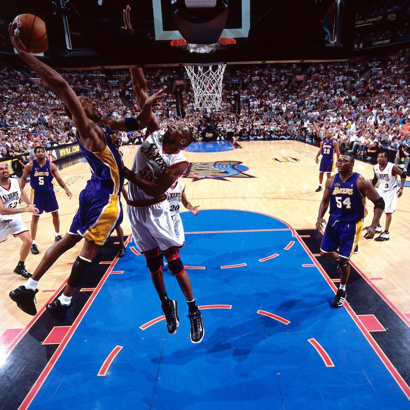 Dikembo Mutombo rises to try and block a dunk by Kobe Bryant during the 2001 NBA Finals.