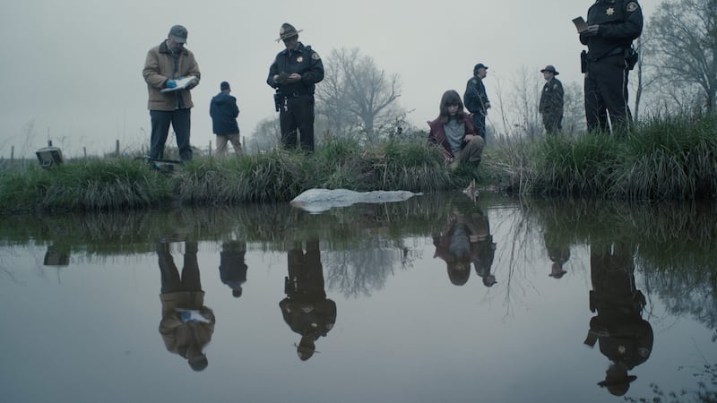 Young Darby and investigators at river’s edge.