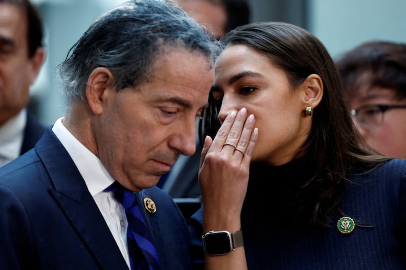 U.S. Rep. Alexandria Ocasio-Cortez (D-NY) whispers to Ranking Member U.S. Representative Jamie Raskin (D-MD)