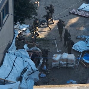 Israeli soldiers walk at the Al Shifa hospital complex, amid their ground operation against Palestinian Islamist group Hamas, in this still image from handout video obtained November 15, 2023.