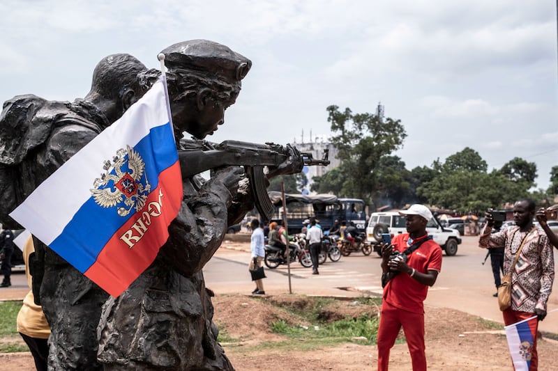 A photograph of a Russian flag with the emblem of Russia on hang on the monument of the Russian instructors in Bangui, on March 22, 2023 during a march in support of Russia's presence in the Central African Republic. 