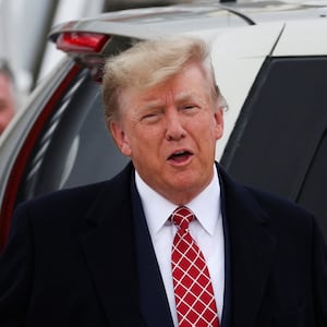 Former president Donald Trump reacts after arriving at Aberdeen International Airport in Aberdeen, Scotland.