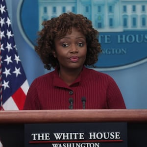 Biden Press Secretary Karine Jean-Pierre stands at a podium