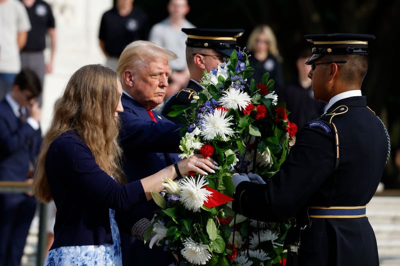 Donald Trump stands alongside the sister of a soldier who was killed in Afghanistan in 2021.