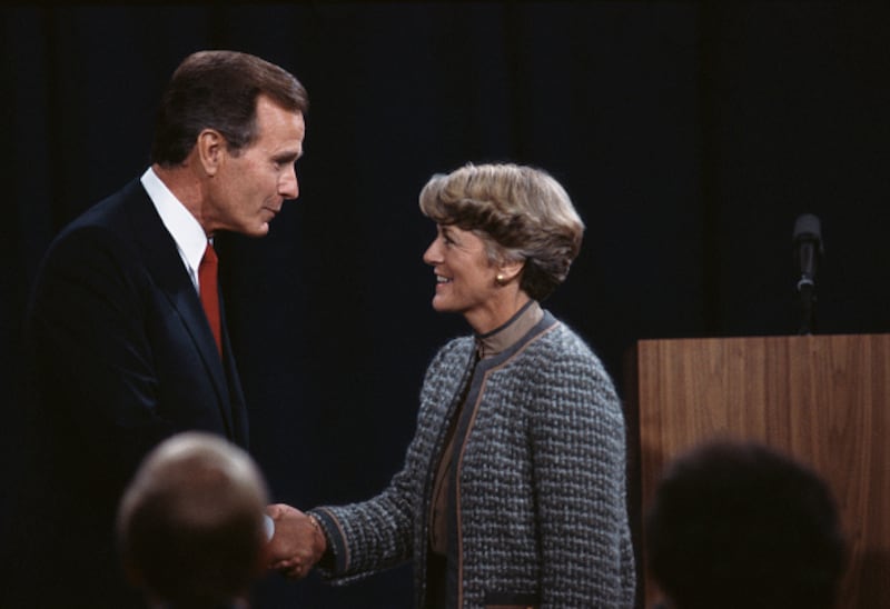 George Bush and Geraldine Ferraro shake hands.