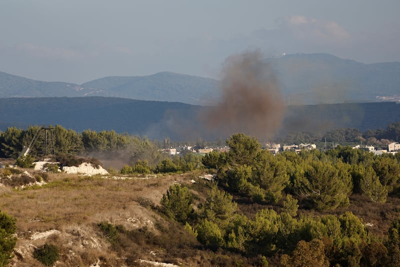 A photo taken by Thaier Al-Sudani on Friday, which shows a plume of smoke rising over an otherwise serene landscape.