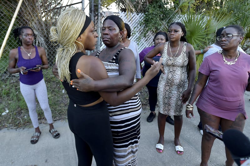 A neighbor arrives at the scene of a shooting at the Dollar General store in Jacksonville, Florida.