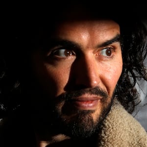 Comedian Russell Brand poses for photographers before signing copies of his new book entitled “Revolution” in central London, December 5, 2014.