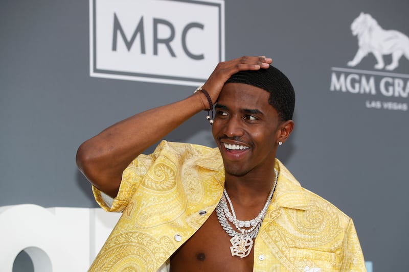 Christian Combs poses at a red carpet event.