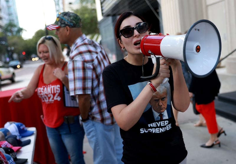 Laura Loomer shows her support for former President Donald Trump outside a campaign event for Republican presidential candidate Florida Gov. Ron DeSantis