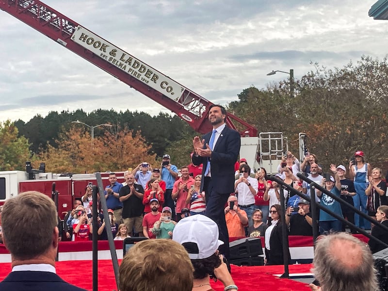 J.D. Vance claps himself on stage at his rally.