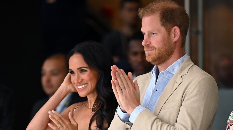 Britain's Prince Harry (C), Duke of Sussex, and his wife Meghan Markle react while attending a show during a visit to the National Centre for the Arts in Bogota on August 15, 2024. Prince Harry and his wife, American actress Meghan Markle, arrived in Colombia at the invitation of Colombia's vice-President Francia Marquez, with whom they will attend various meetings with women and young people to reject discrimination and cyberbullying.